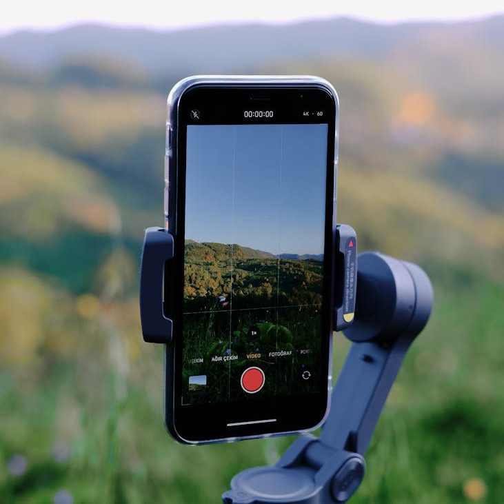 smartphone on holder with mountain view on screen